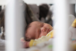 newborn baby sleeping in crib