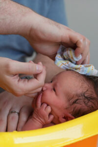 newborn baby getting hair washed
