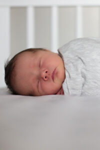 baby sleeping in crib, at home newborn photography session