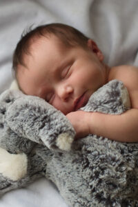 baby hugging stuffed animal