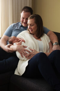 mom and dad holding newborn, at home newborn photography session