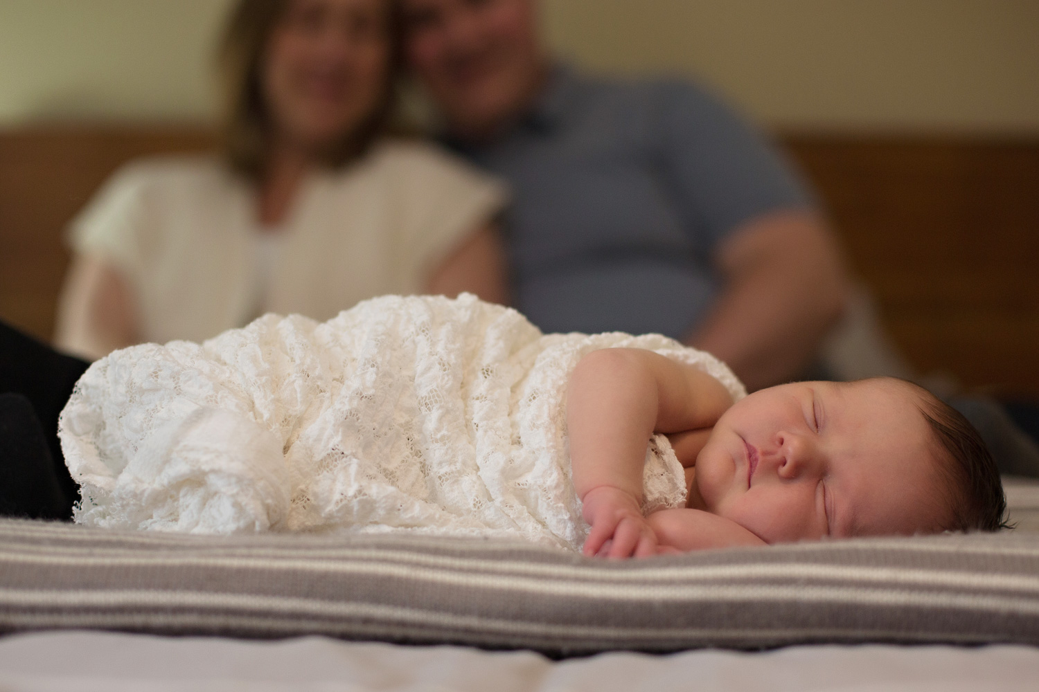 newborn on parents bed, newborn photography session
