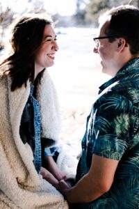 engaged couple smiling at each other