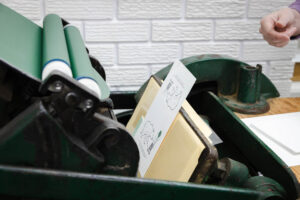 card being printed on a letterpress
