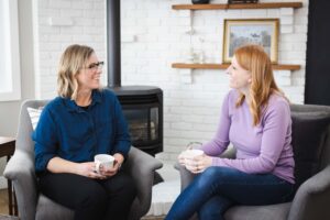 two female business owners chatting over coffee