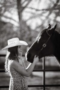 cowgirl smiling at her horse personalized Calgary grad photo session