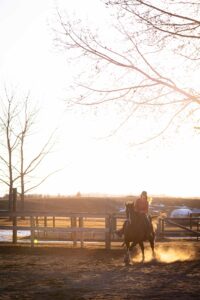 girl barrel racing at golden hour personalized Calgary grad session