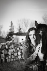 high school graduate and her horse at golden hour Calgary grad photo session black and white