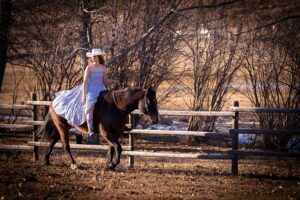 girl riding horse bare back in long flowing dress personalized Calgary grad photo session