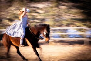 motion blur photo of girl riding horse bare back personalized Calgary grad photo session