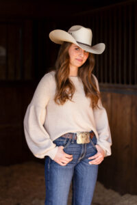 portrait of a cowgirl in her barn personalized Calgary grad photo session
