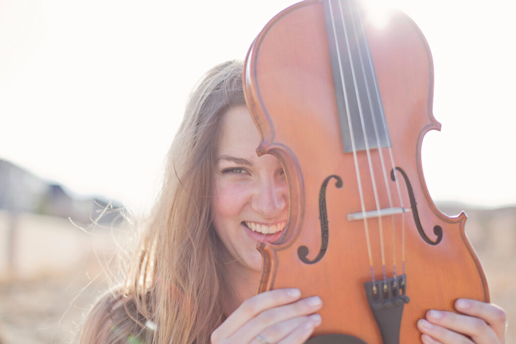 high school graduate celebrating with violin