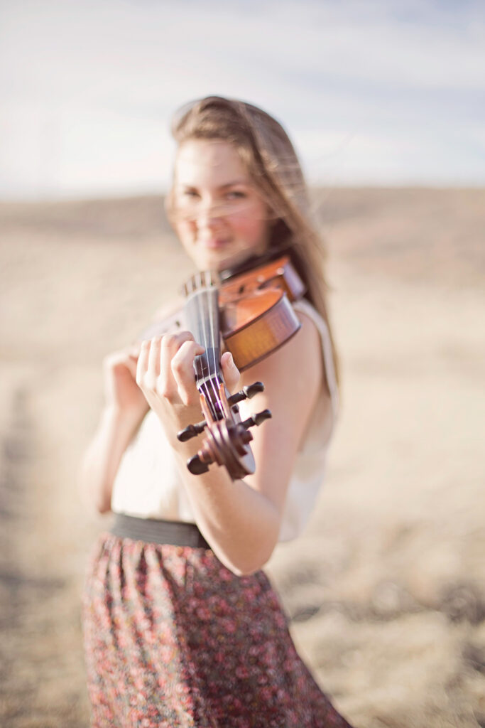 high school graduate celebrating with violin