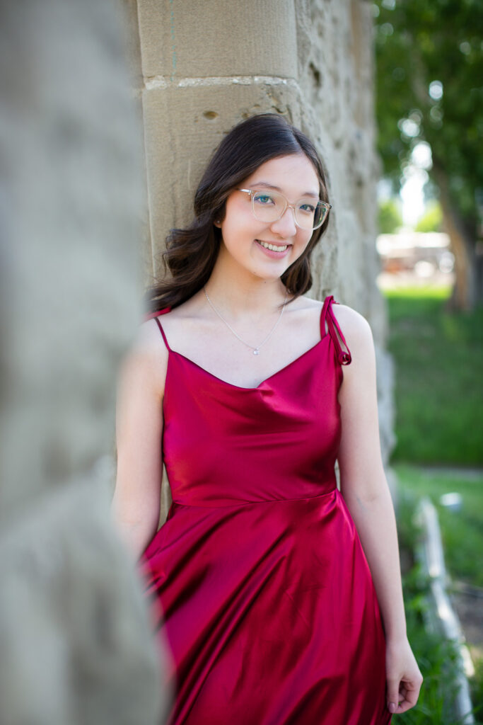 high school graduate posing in flowing dress at Rundle Ruins