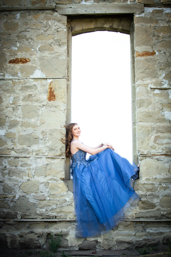 high school graduate posing in flowing dress at Rundle Ruins