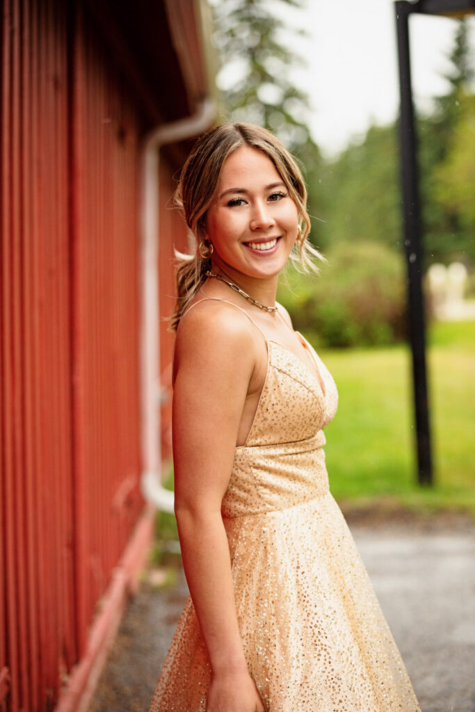 high school graduate posing in flowing prom dress at Fish Creek Park