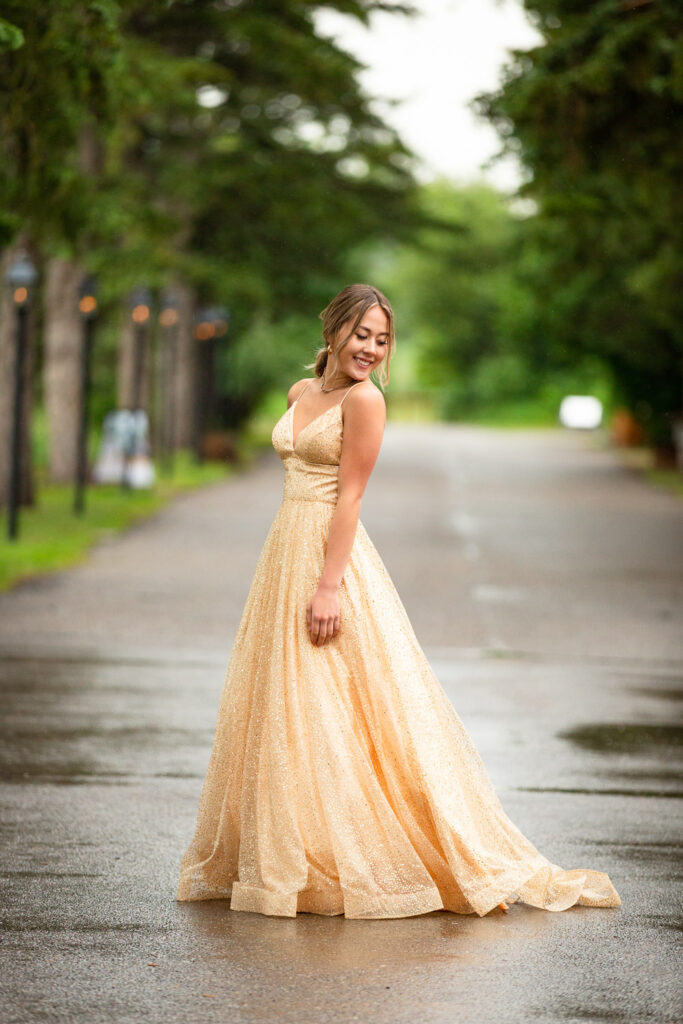 high school graduate posing in flowing prom dress at Fish Creek Park