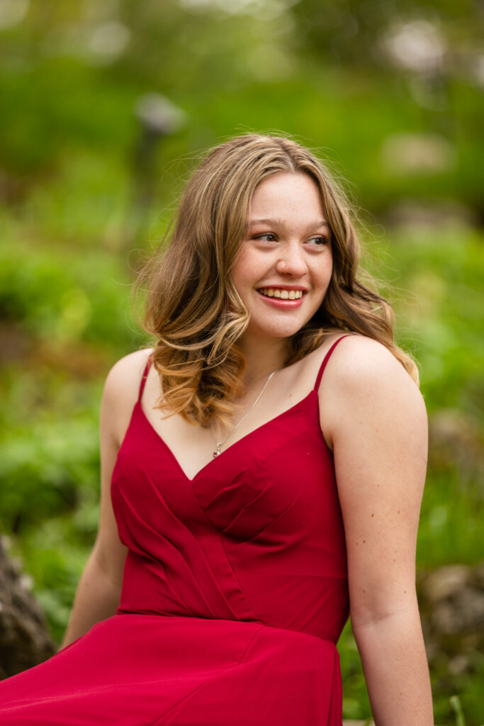 high school graduate posing in flowing prom dress at Reader Rock Garden