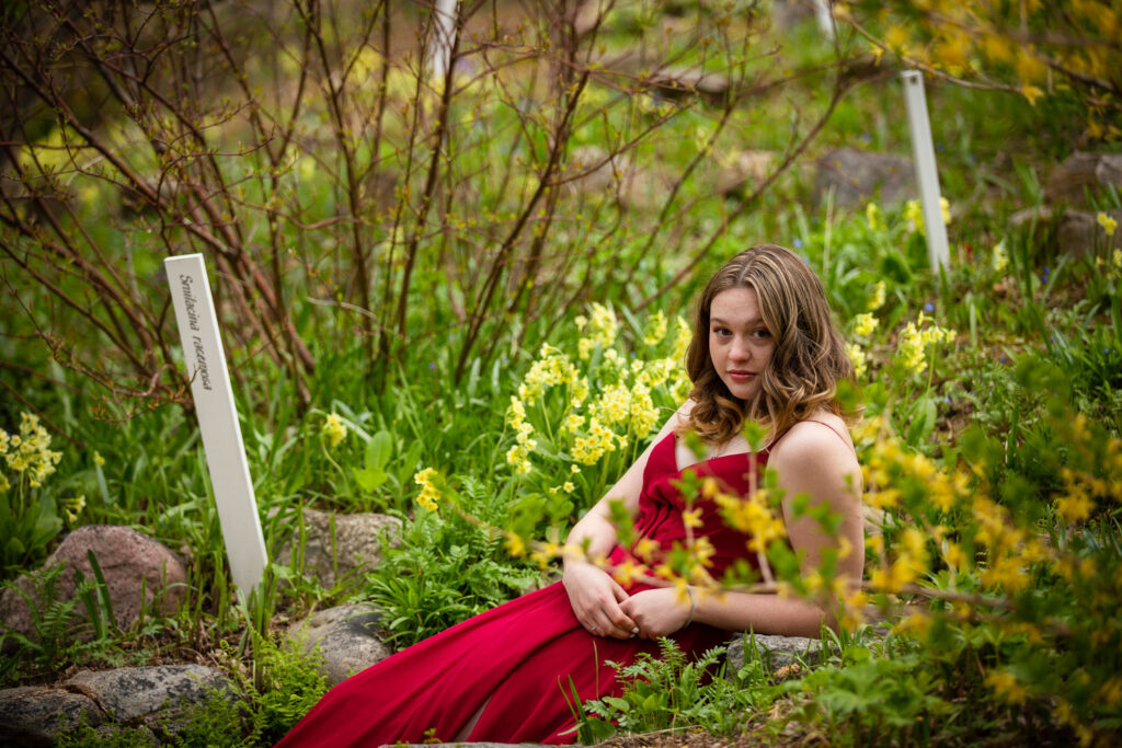 high school graduate posing in flowing prom dress at Reader Rock Garden