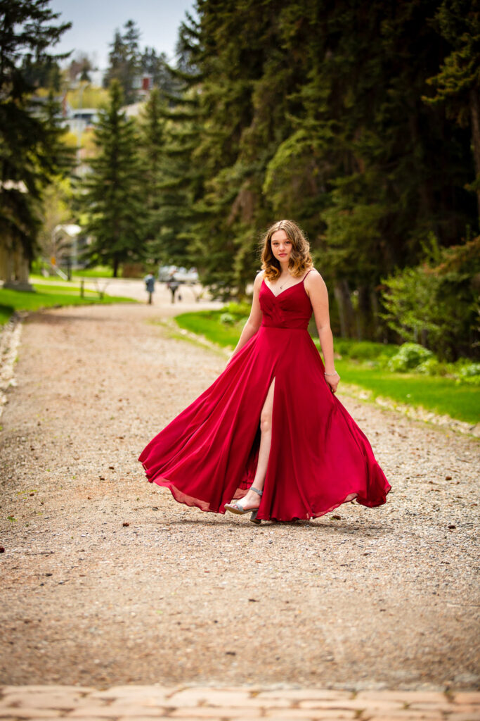 high school graduate posing in flowing prom dress at Reader Rock Garden