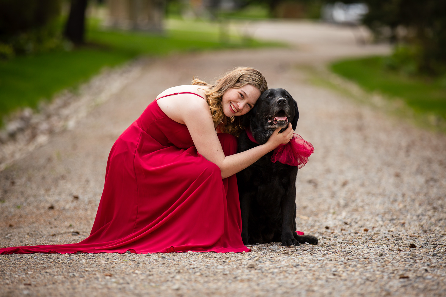 high school graduate in prom dress with her dog