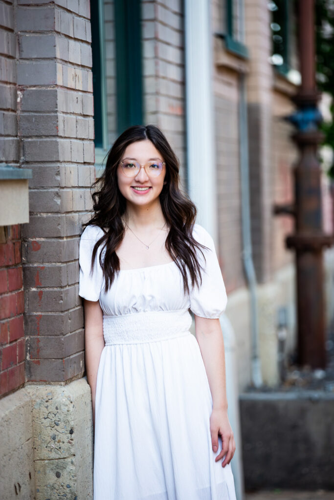 high school graduate informal portrait in white dress