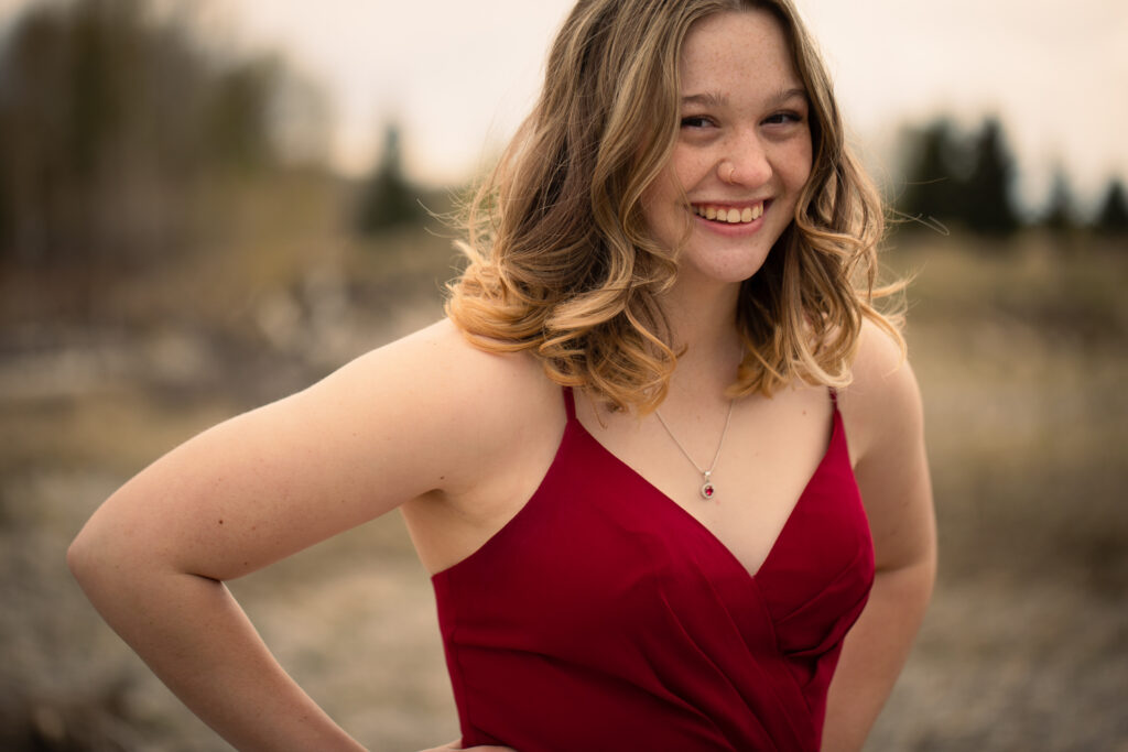 beautiful high school graduate smiling in dress