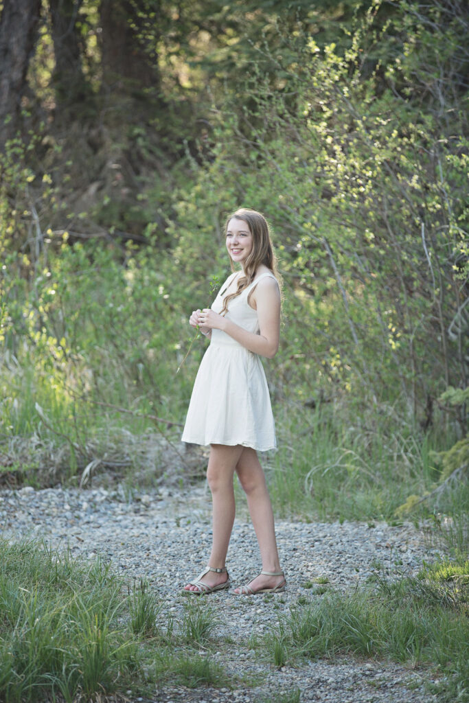 high school graduate posing on path in Griffith Woods Calgary Alberta
