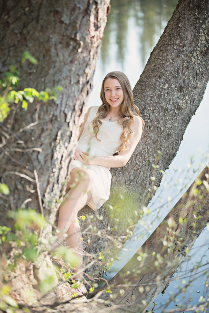 high school graduate sitting in a tree Griffith Woods Calgary Alberta