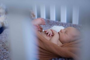 newborn baby in crib