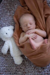 newborn baby in crib at home newborn photography session Calgary