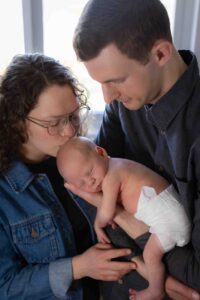 at home newborn photography session Calgary mom and dad with baby