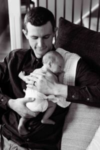 new dad with baby at home newborn photography session Calgary