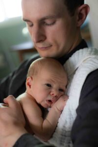 newborn baby with dad at home newborn photography session Calgary
