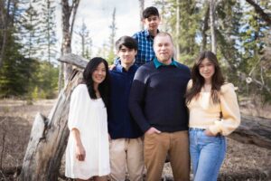 family posing for picture in griffith woods park calgary