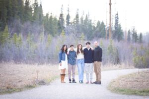 family posing for picture in griffith woods park calgary