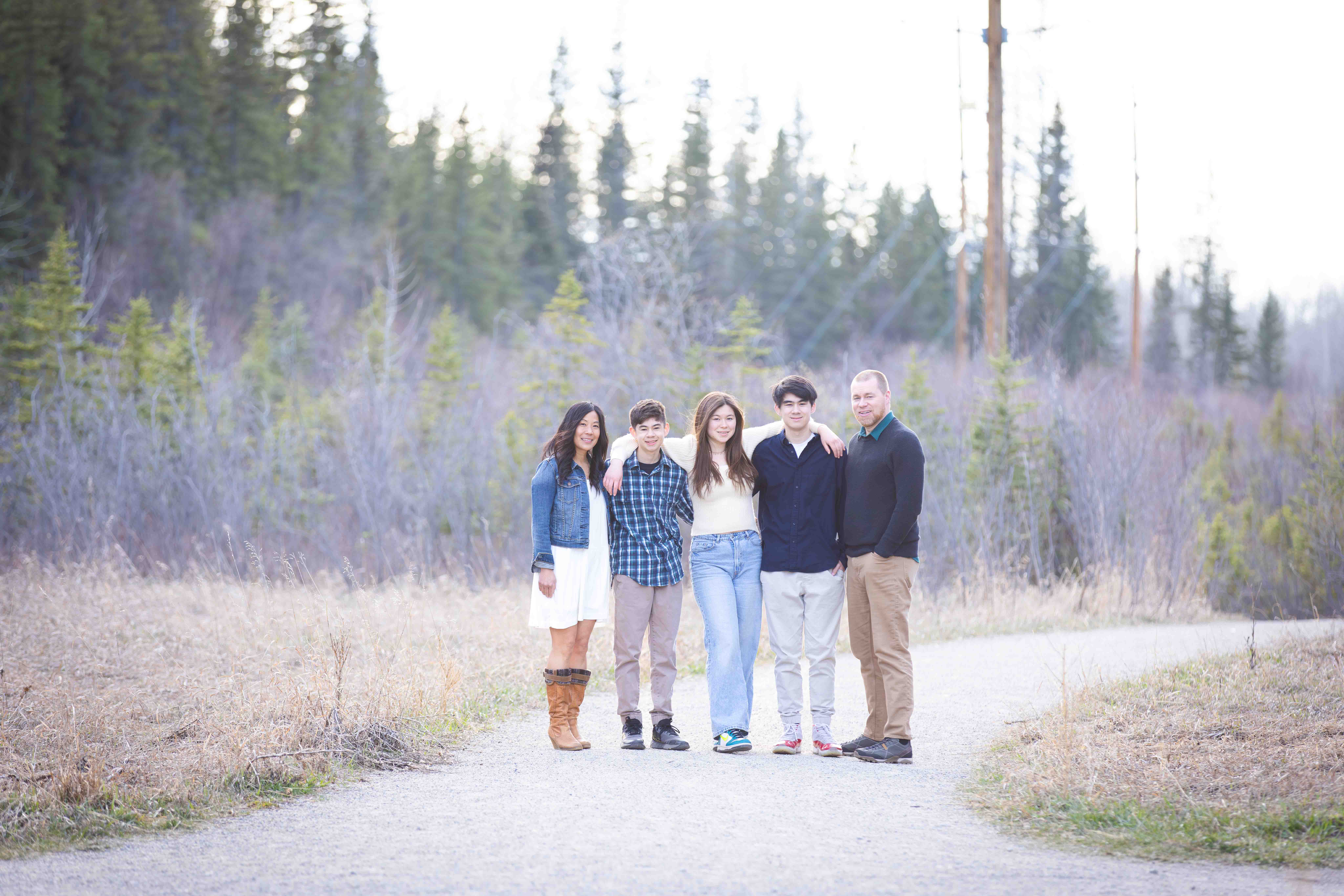 family posing for picture in griffith woods park calgary