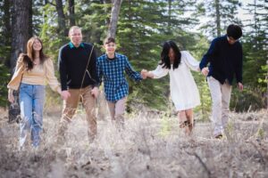 family having fun together in Griffith woods park calgary