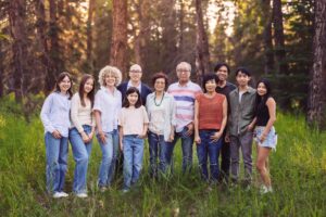 extended family posing for photo in griffith woods park calgary family photo session
