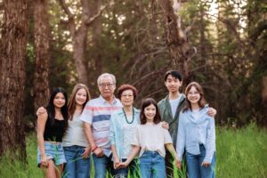 50th anniversary couple posing with grandchildren in griffith woods park calgary family photo session