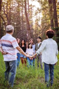 50th anniversary couple posing with grandchildren in griffith woods park calgary family photo session
