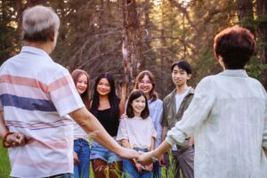 50th anniversary couple posing with grandchildren in griffith woods park calgary family photo session