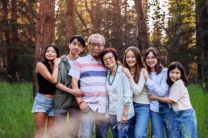 50th anniversary couple posing with grandchildren in griffith woods park calgary family photo session