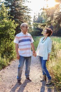 50th anniverary couple smiling at each other in golden hour light calgary family photo session
