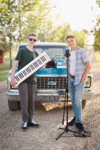 two high school musicians posing with their instruments