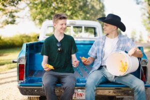 two high school students joking around Calgary grad photoshoot
