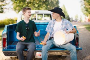 two high school students joking around Calgary grad photoshoot
