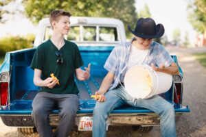 two high school students joking around Calgary grad photoshoot