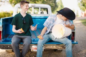two high school students joking around Calgary grad photoshoot
