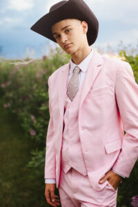 high school graduate posing in pink suit calgary grad photoshoot